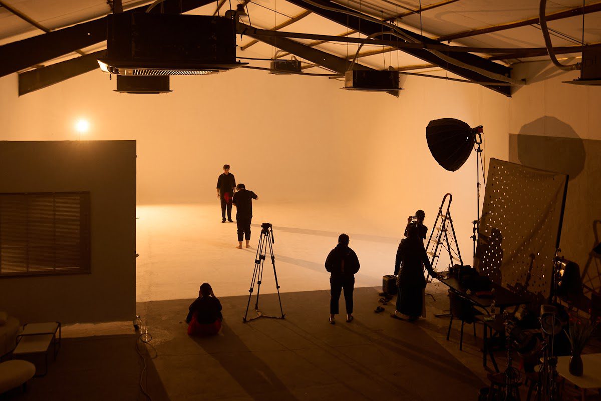Studio pre-rigged with cameras and softbox lighting for a podcast shoot in Da Nang