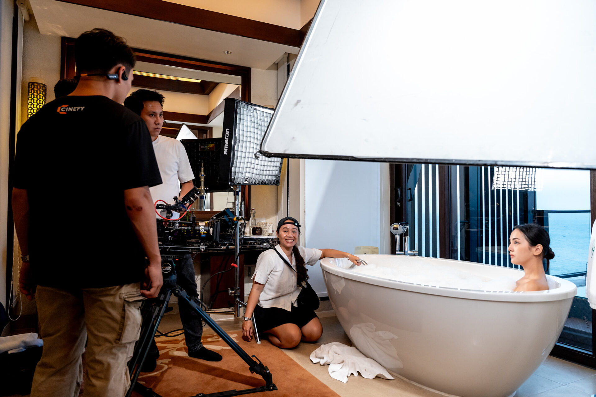 CINEFY crew filming a commercial scene with talent and a large softbox on location in Da Nang