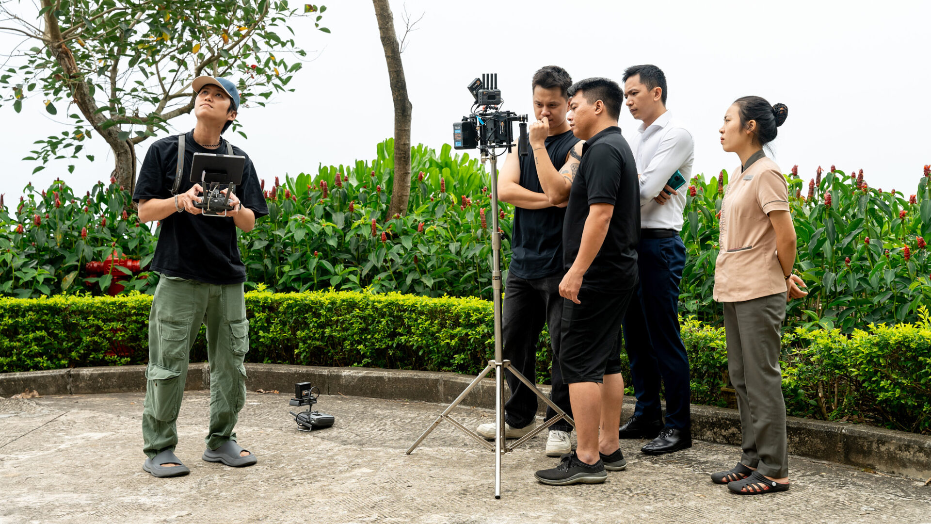 CINEFY production team scouting an outdoor location with a camera on tripod before a TVC shoot in Da Nang