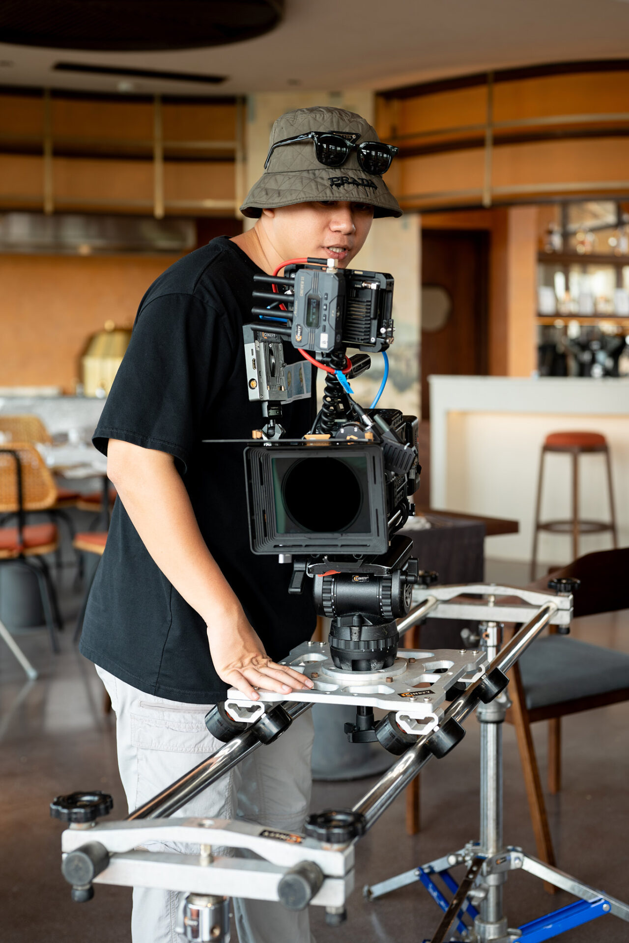 CINEFY technician handling a rigged camera with matte box before a take