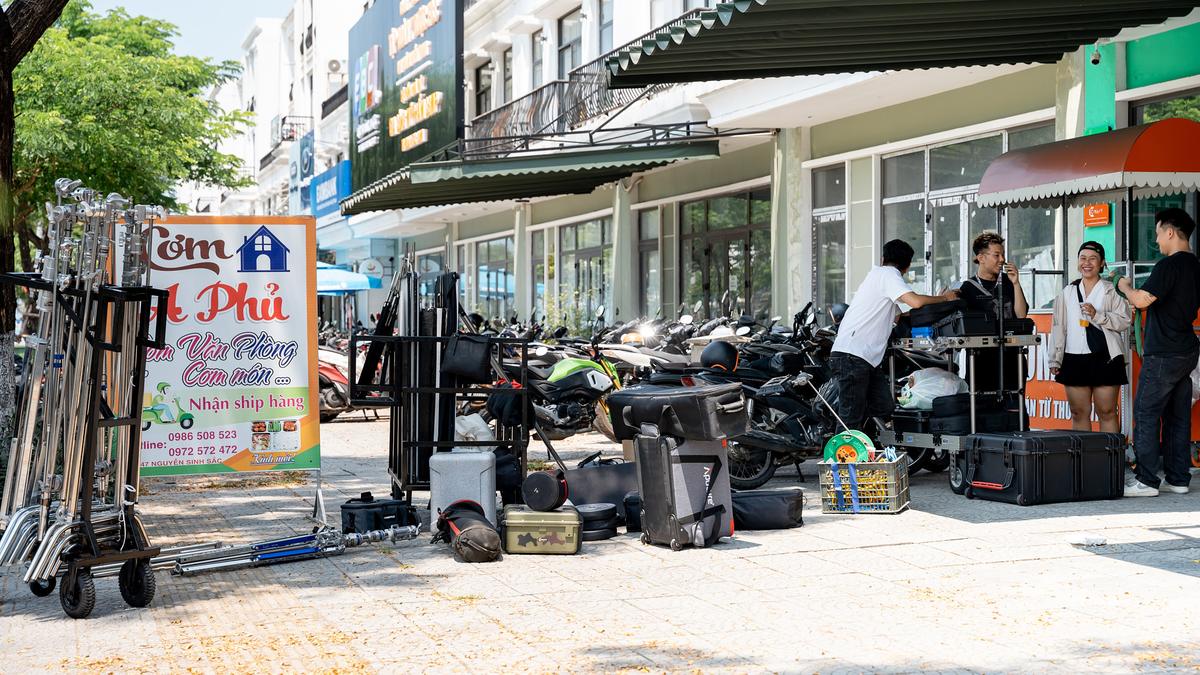 Equipment carts loaded with CINEFY camera cases staged on a street in Da Nang
