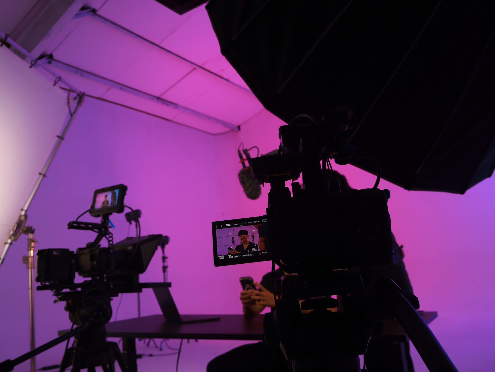 A cinema camera and monitors during a podcast recording at the CINEFY studio in Da Nang.