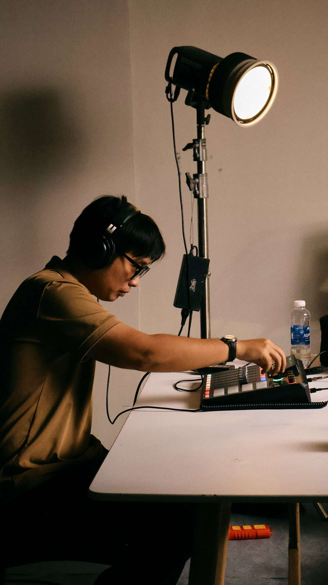 Audio technician checking recorder levels before a podcast session at a podcast studio in Da Nang.