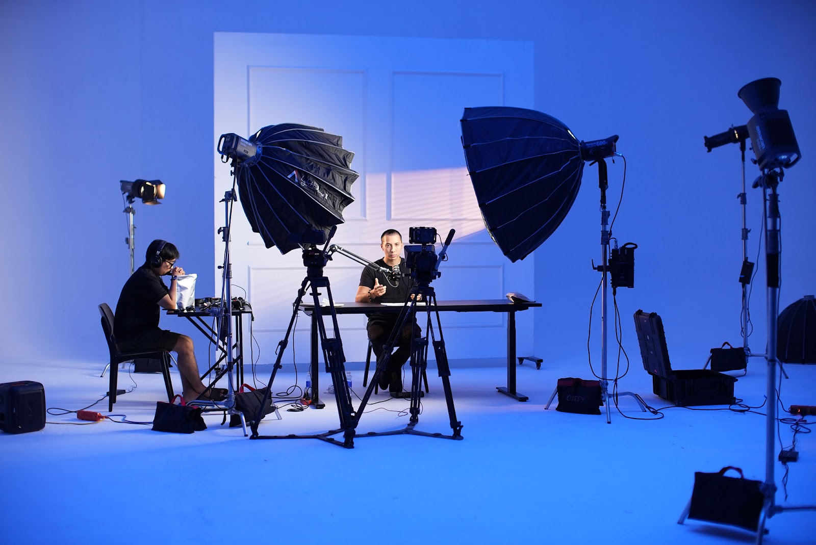 Multi-camera podcast studio setup in Da Nang with softbox lighting and crew preparing the set at CINEFY.