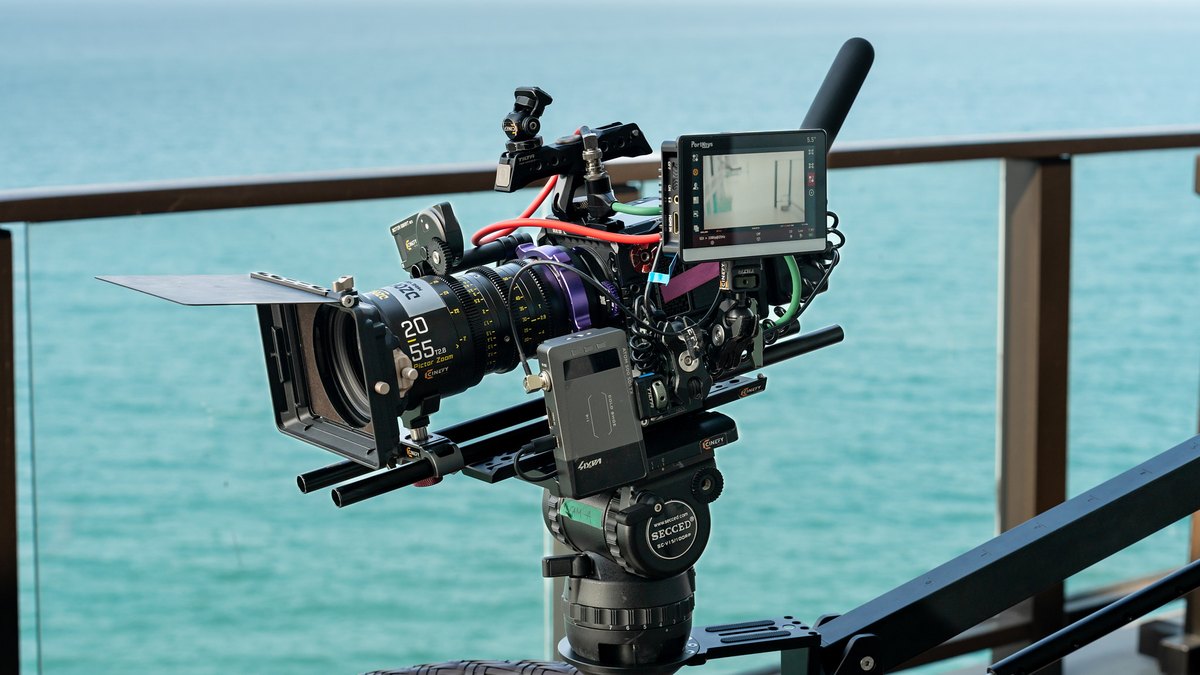 Cinema camera with a cine lens and monitor set up outdoors in bright sun by the coast in Da Nang