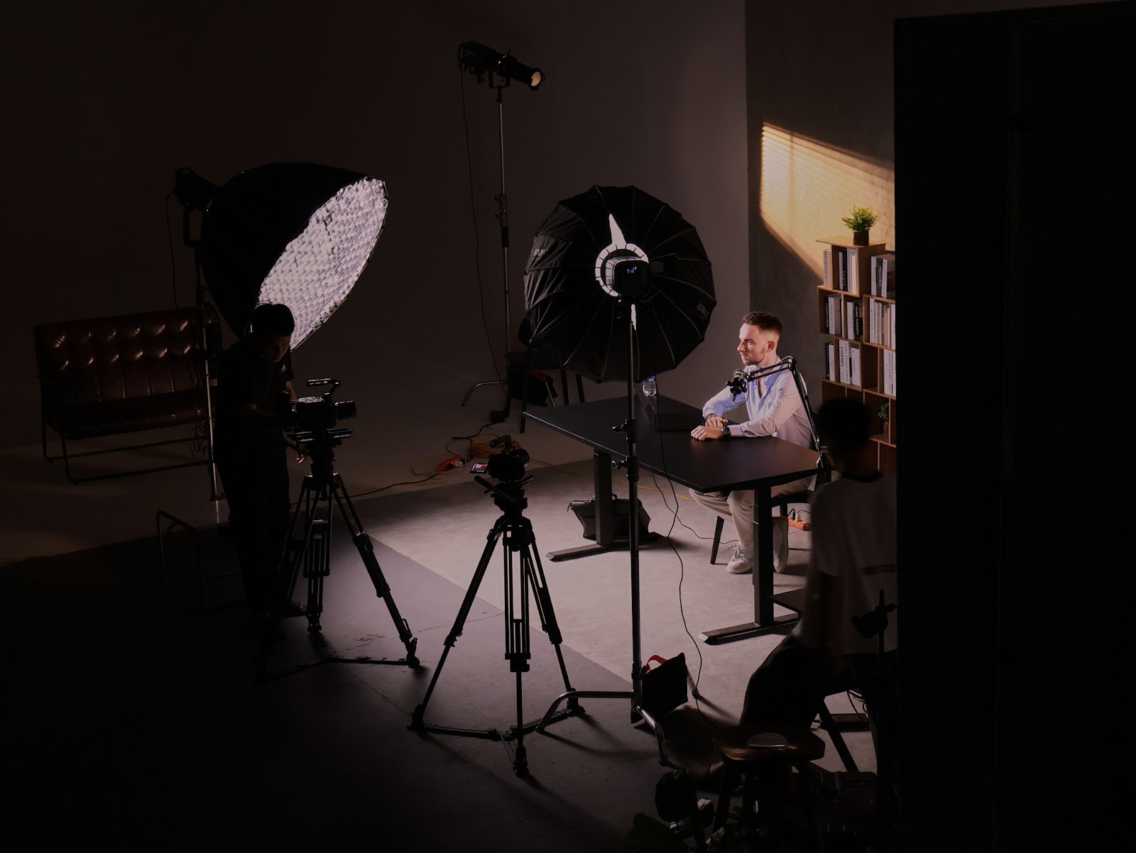 A pre-built podcast recording set with softboxes and tripods inside the CINEFY studio in Da Nang.