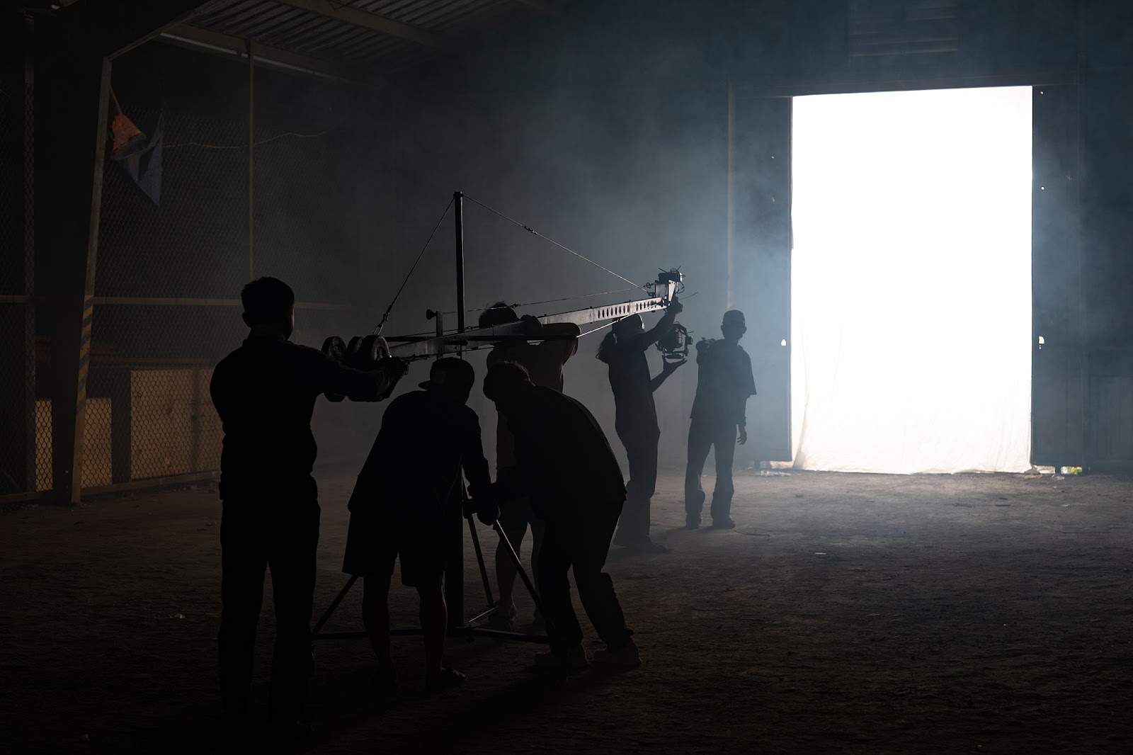 The CINEFY crew rigs lighting on a custom-built set during a video production shoot in Da Nang.
