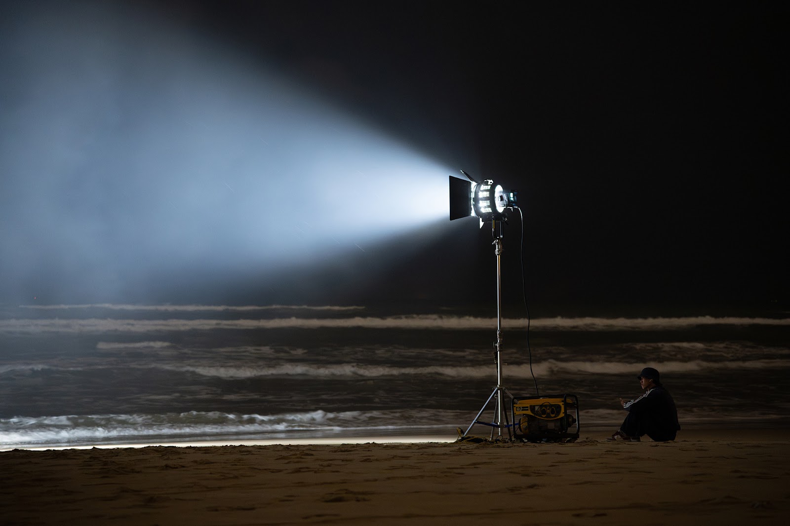CINEFY crew lighting a night video production on My Khe Beach in Da Nang.