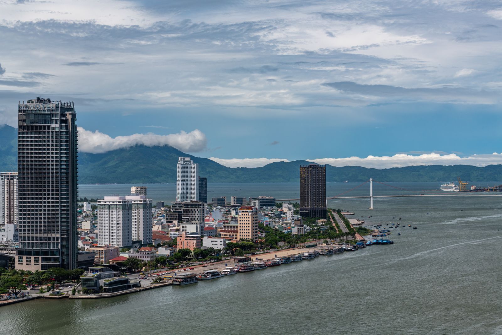Elevated panorama of central Da Nang with the Han River, Thuan Phuoc Bridge and mountains in the distance.