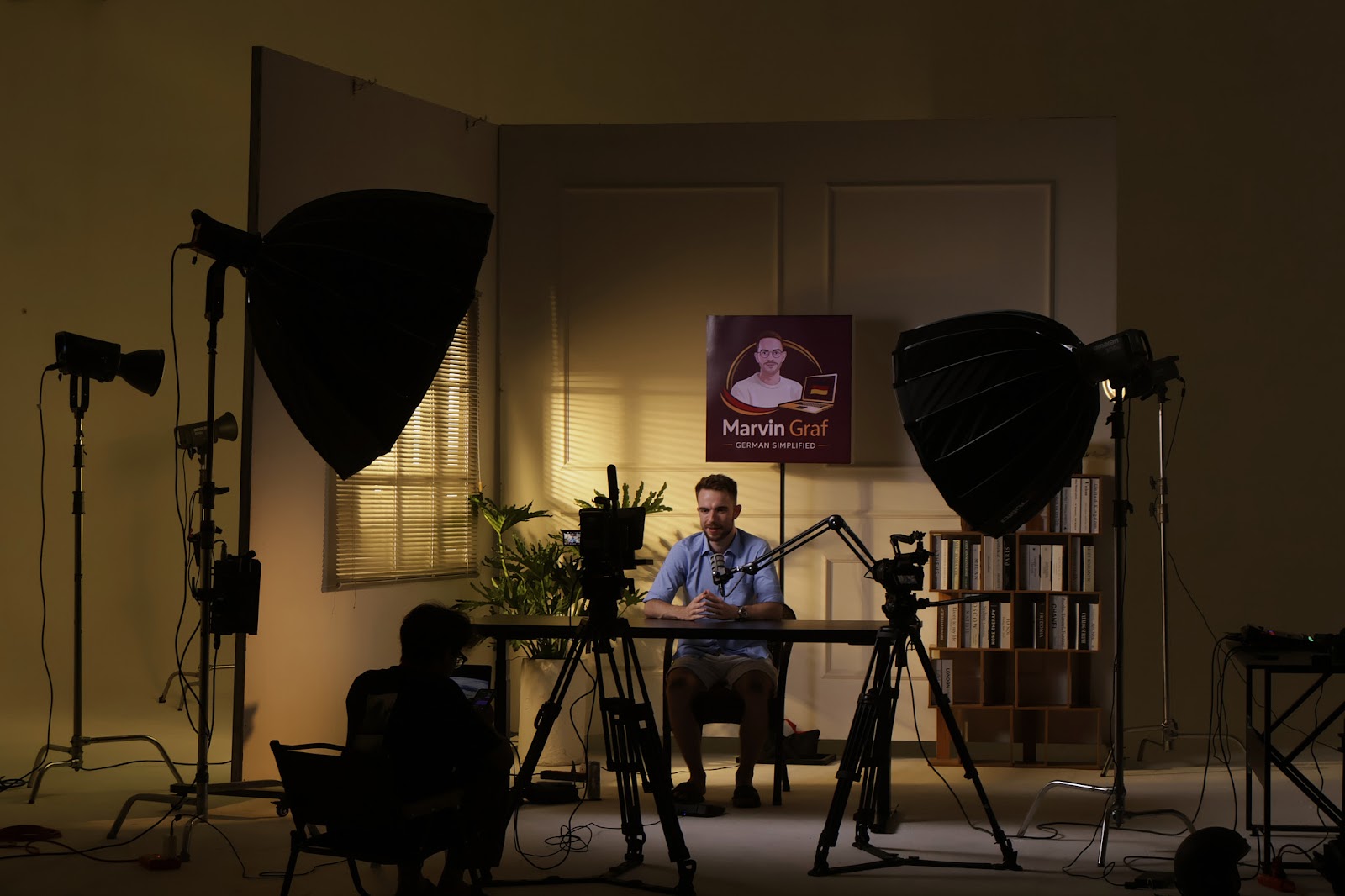 A talking-head session at CINEFY studio in Da Nang with two softboxes and a bookshelf backdrop
