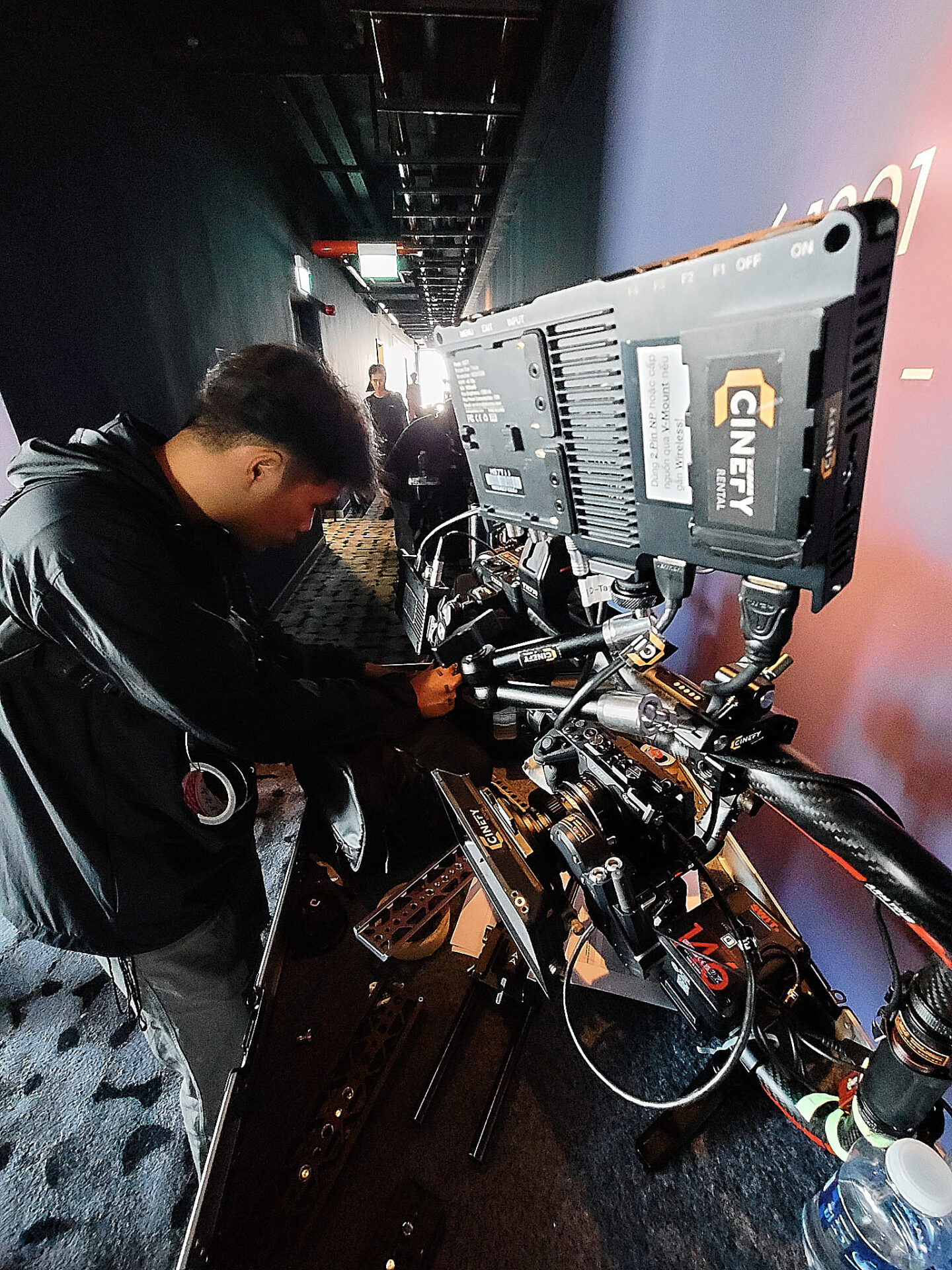 A CINEFY crew member checking a camera rig and cabling before a take on a Da Nang production