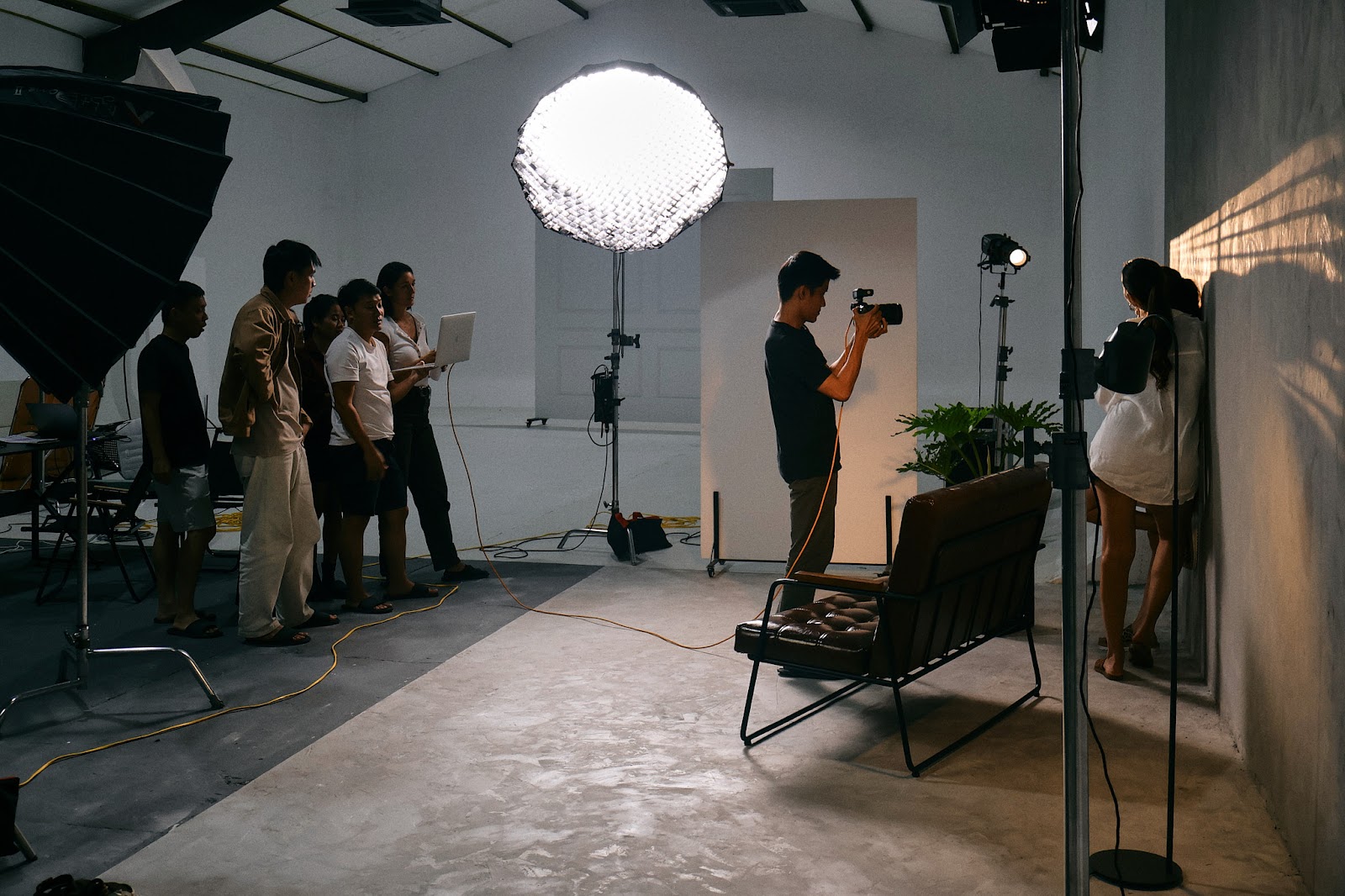 The CINEFY crew working around a monitor during a shoot at the Da Nang studio