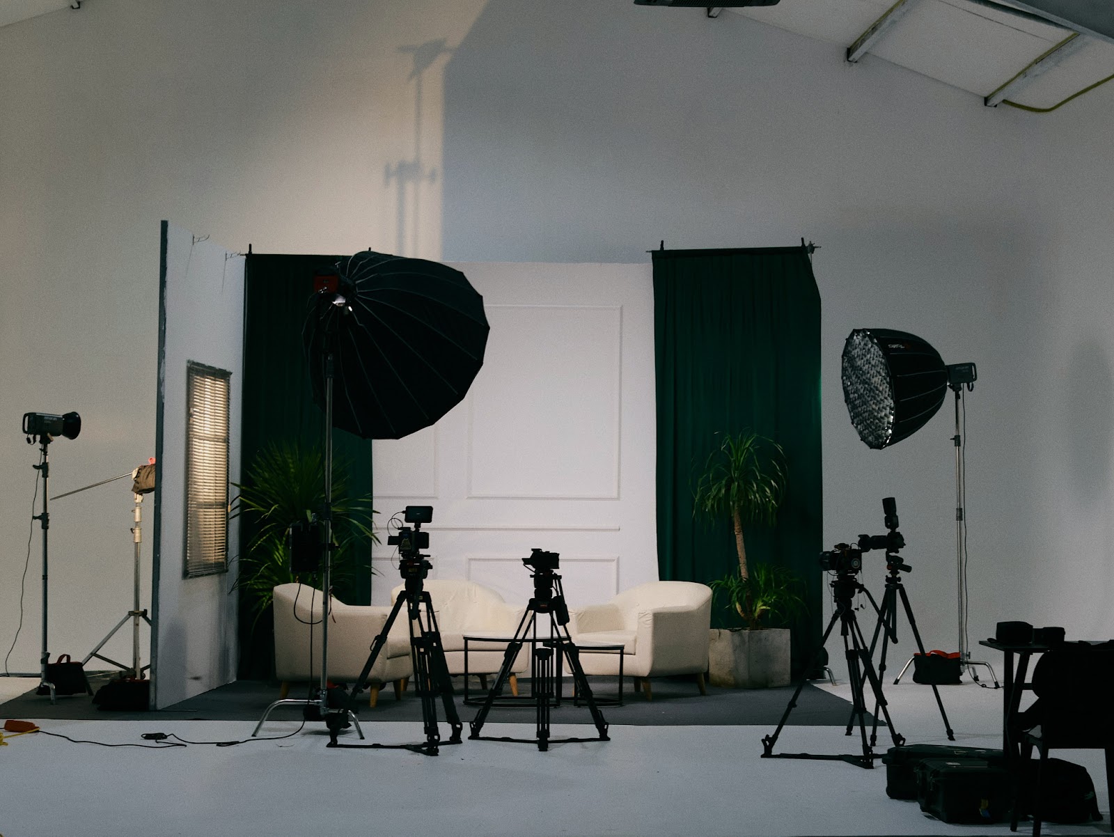 Two parabolic softboxes and light stands rigged for a talking head shoot at the CINEFY studio in Da Nang