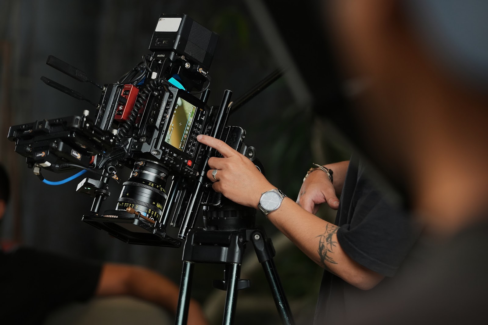 A CINEFY technician adjusting a cinema camera on location in Da Nang