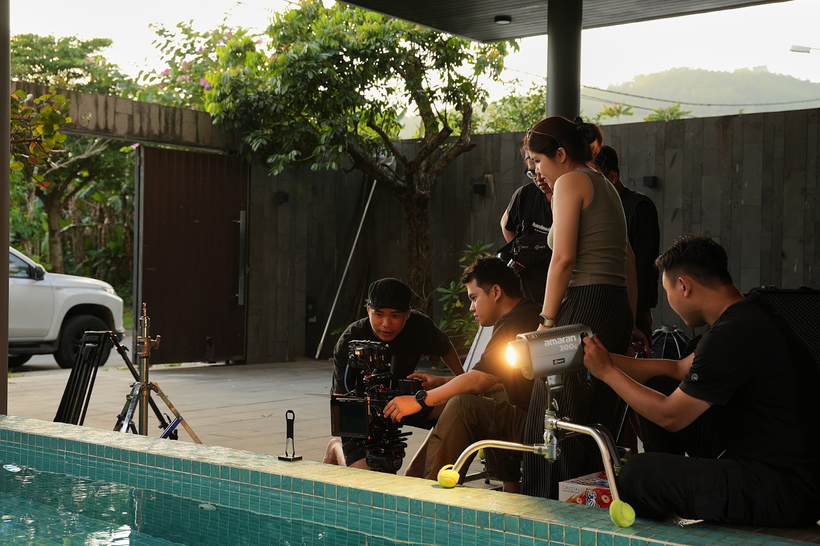 CINEFY crew setting up lighting for an outdoor shoot in Da Nang